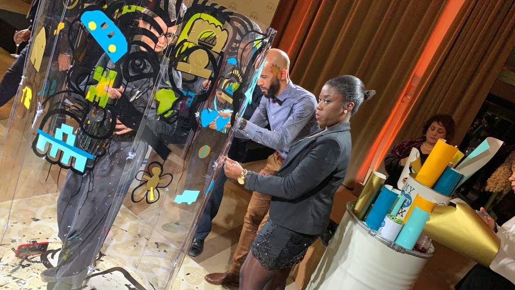 aNa artist works out Collaborative Action Art Painting inside a huge plexiglass tube : The paint Tube